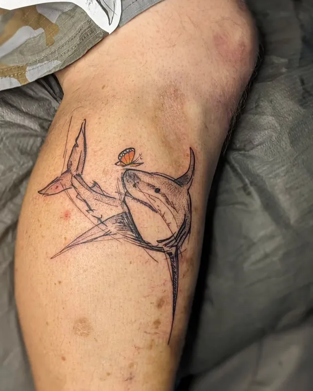 Sketchy linework shark tattoo on a calf